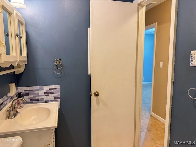 bathroom featuring decorative backsplash, tile patterned flooring, and vanity