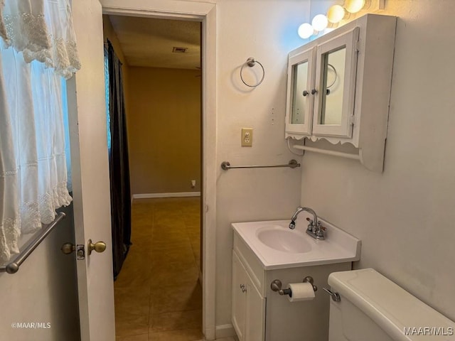 bathroom with tile patterned floors, vanity, and toilet