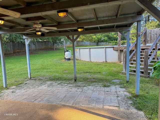 view of patio featuring ceiling fan and a fenced in pool