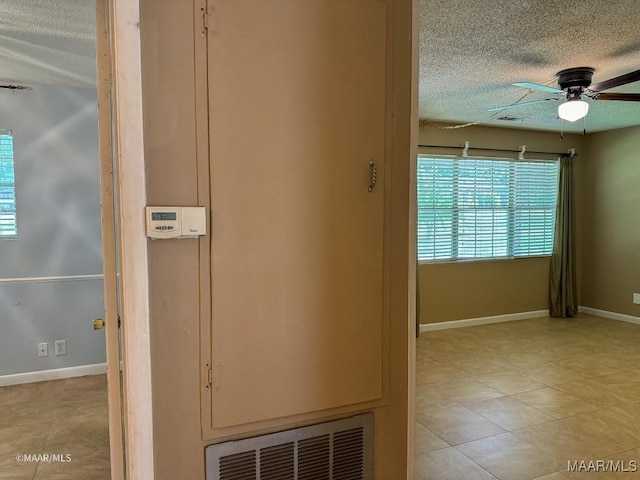 interior space with ceiling fan