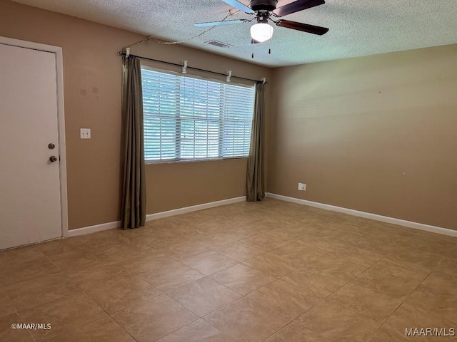 empty room with a textured ceiling and ceiling fan