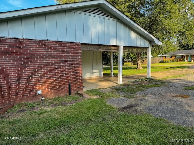 view of property exterior with a carport and a yard