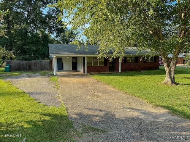 view of front of home with a front lawn and a carport