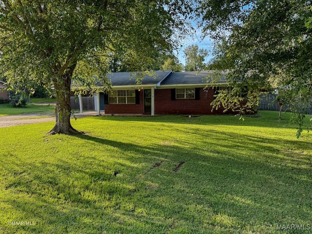 ranch-style home featuring a front yard