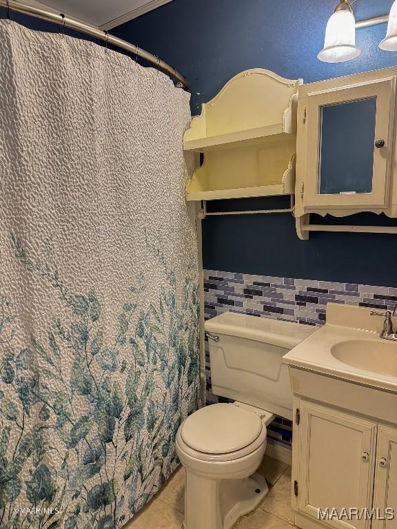 bathroom featuring tile patterned floors, tasteful backsplash, vanity, and toilet