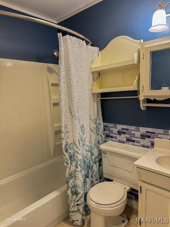 full bathroom with vanity, backsplash, shower / bath combination with curtain, crown molding, and toilet