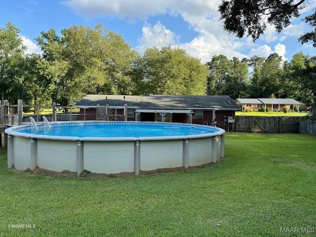 view of pool with a lawn