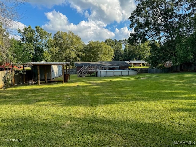 view of yard featuring a covered pool