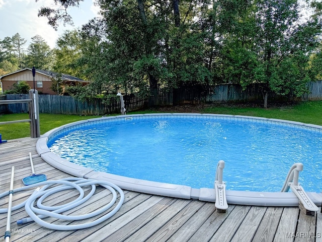 view of swimming pool with a wooden deck