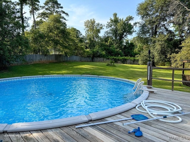 view of swimming pool featuring a yard and a wooden deck