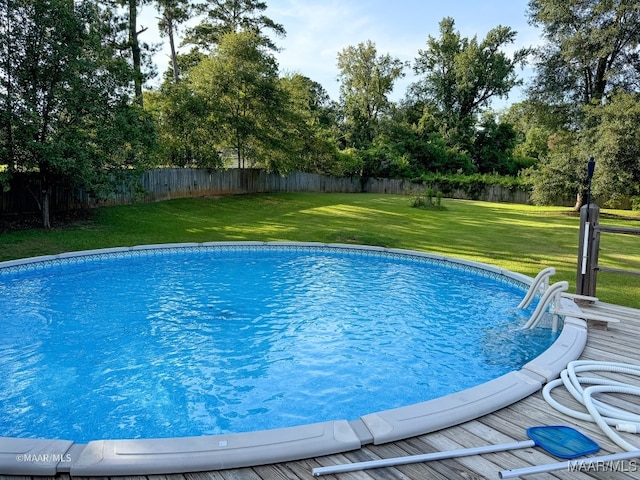 view of pool featuring a yard