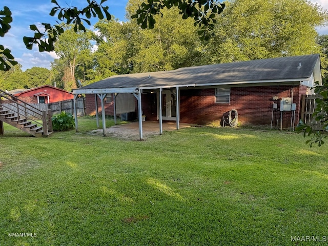 rear view of house with a yard