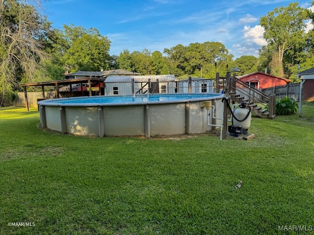 view of swimming pool with a yard