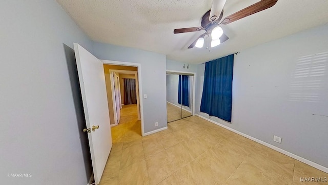 unfurnished bedroom featuring a textured ceiling, a closet, and ceiling fan