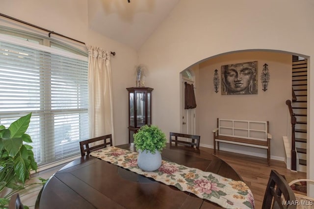 dining space featuring lofted ceiling and light hardwood / wood-style flooring