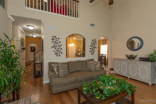 living room with ceiling fan and light wood-type flooring