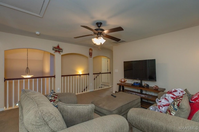 carpeted living room with ceiling fan