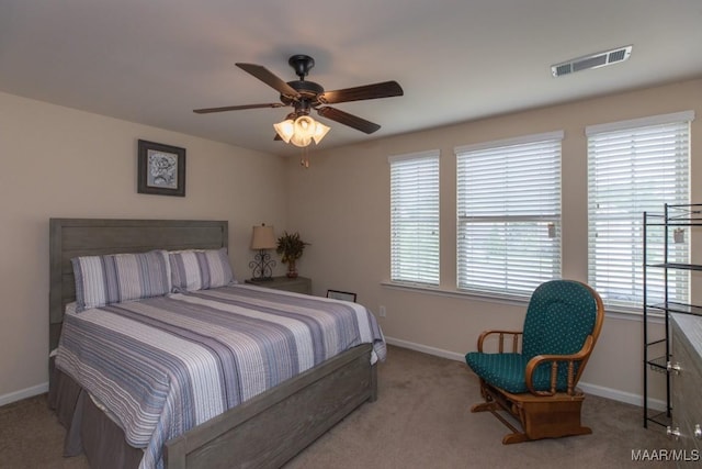 bedroom with light colored carpet and ceiling fan