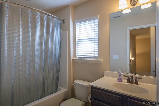 full bathroom with shower / tub combo with curtain, vanity, and toilet