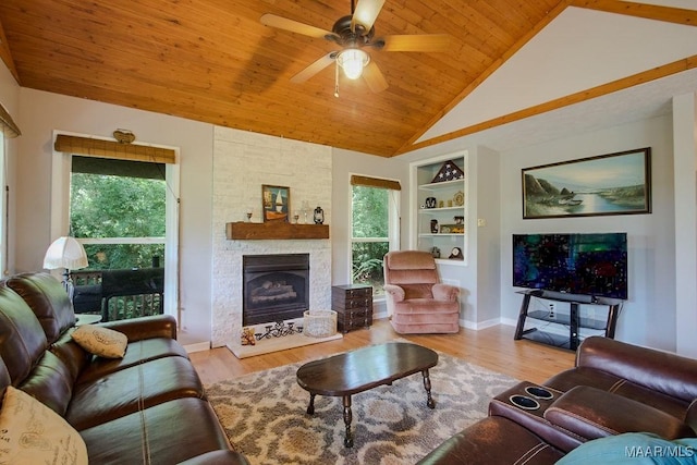 living room featuring vaulted ceiling, wooden ceiling, a healthy amount of sunlight, and built in features