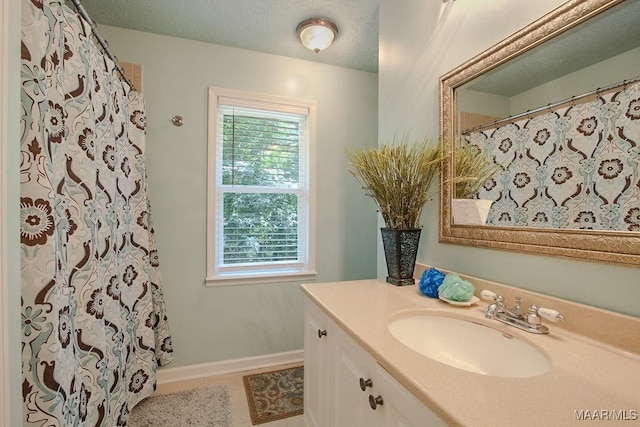 bathroom with vanity, tile patterned floors, a textured ceiling, and a shower with shower curtain