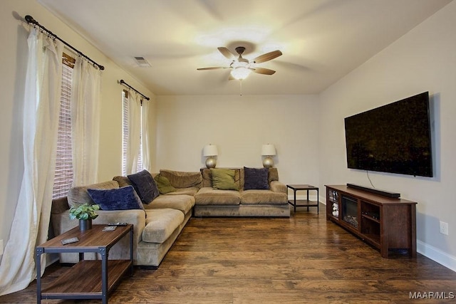 living room with ceiling fan and dark hardwood / wood-style floors