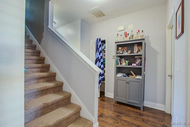 stairway featuring hardwood / wood-style floors