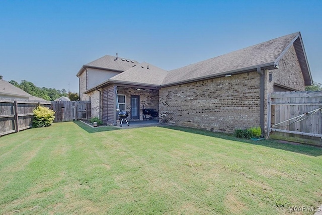 rear view of property featuring a lawn