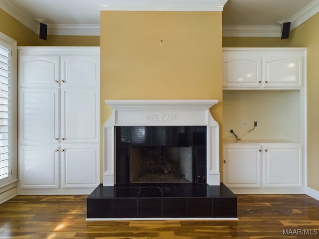 room details featuring crown molding, a fireplace, and hardwood / wood-style flooring