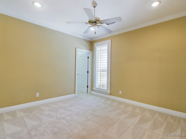 empty room featuring ornamental molding, light carpet, and ceiling fan