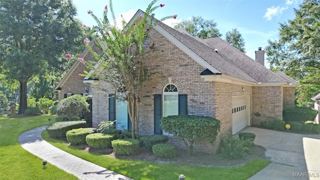 view of home's exterior featuring a garage and a yard