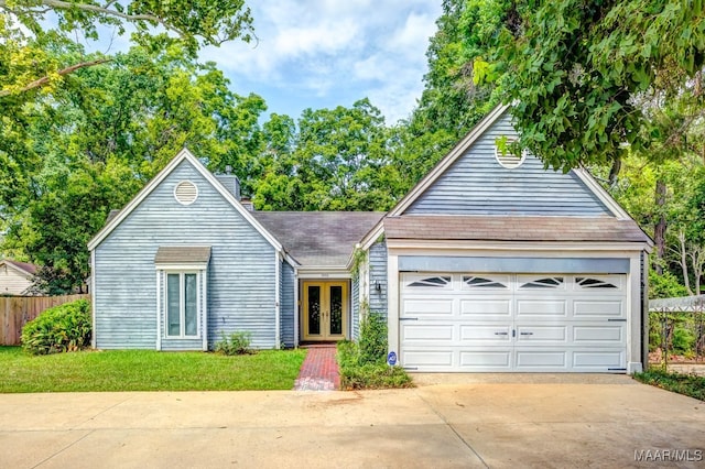 view of front of property featuring a garage and a front yard