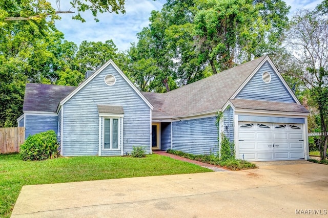 view of front of property with a garage and a front lawn