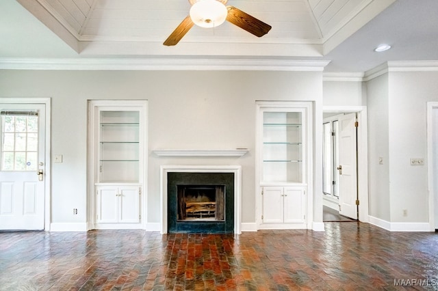 unfurnished living room featuring ceiling fan and ornamental molding