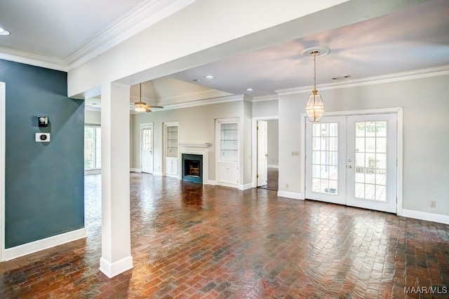 unfurnished living room with ornamental molding, french doors, ceiling fan, and a wealth of natural light