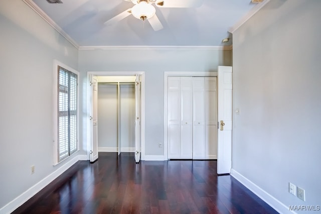 unfurnished bedroom featuring wood-type flooring, multiple windows, and ornamental molding