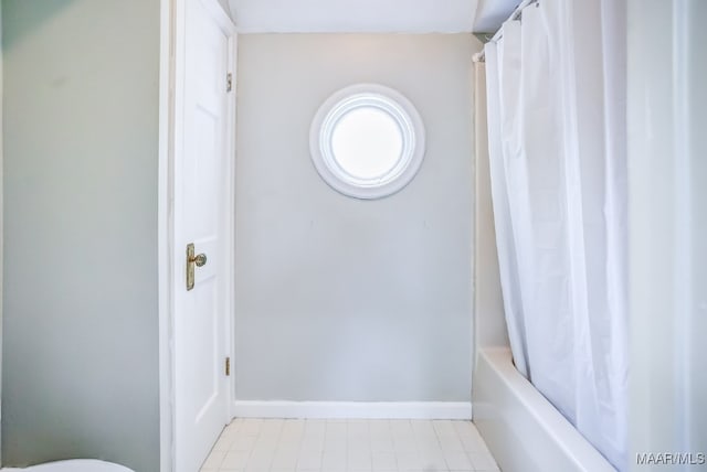 bathroom featuring tile patterned floors and shower / bath combo