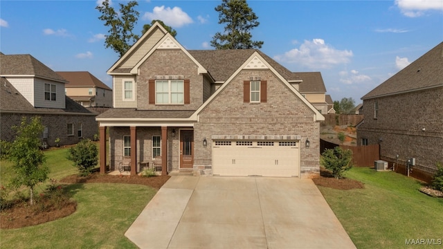 view of front of house with cooling unit, a garage, and a front yard