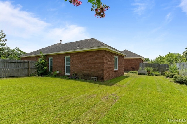 rear view of property featuring a yard