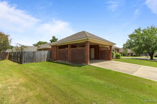 exterior space featuring a carport and a yard