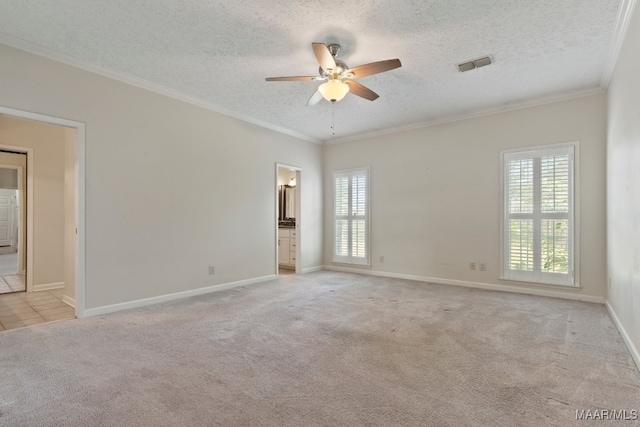 carpeted empty room with a textured ceiling, ornamental molding, and ceiling fan