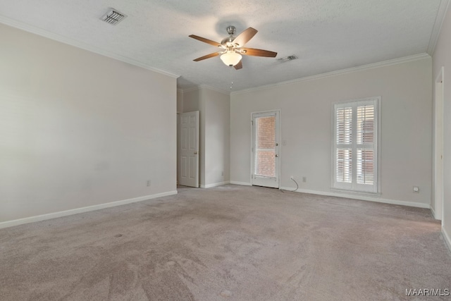 unfurnished room with a textured ceiling, ceiling fan, ornamental molding, and light colored carpet