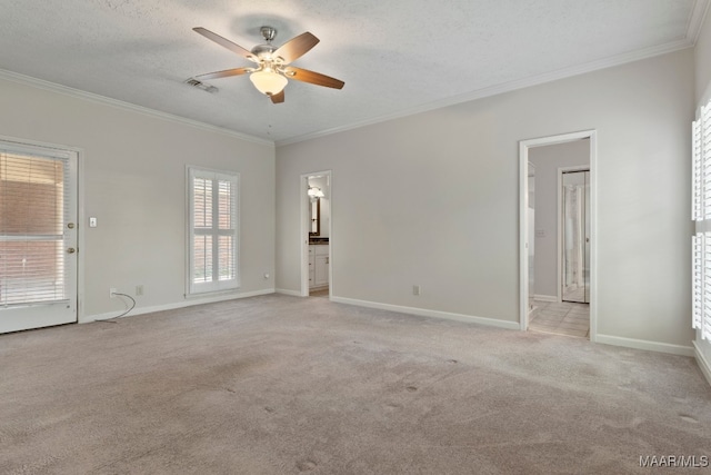 carpeted spare room with crown molding, a textured ceiling, and ceiling fan