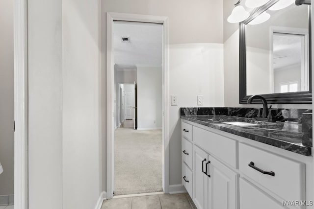 bathroom featuring a textured ceiling, tile patterned floors, vanity, and ornamental molding