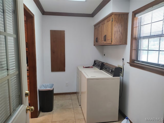 washroom with cabinets, washer and dryer, light tile patterned floors, and crown molding