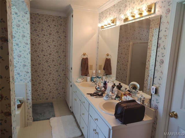 bathroom with crown molding, a bath, tile patterned floors, and double sink vanity