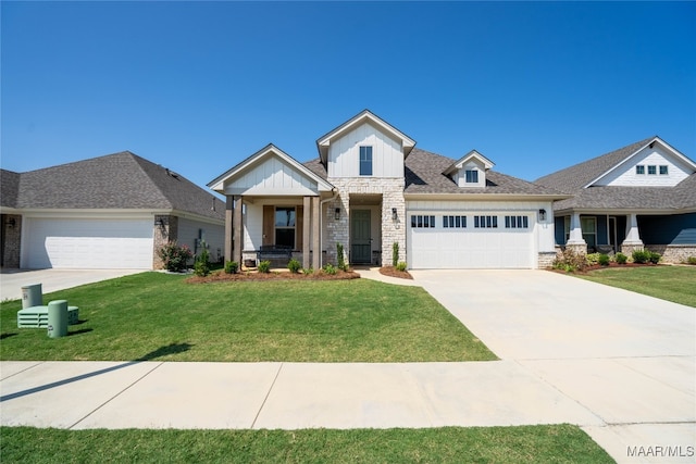 craftsman house with a front yard and a garage