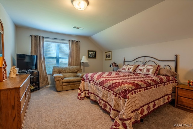 carpeted bedroom with vaulted ceiling