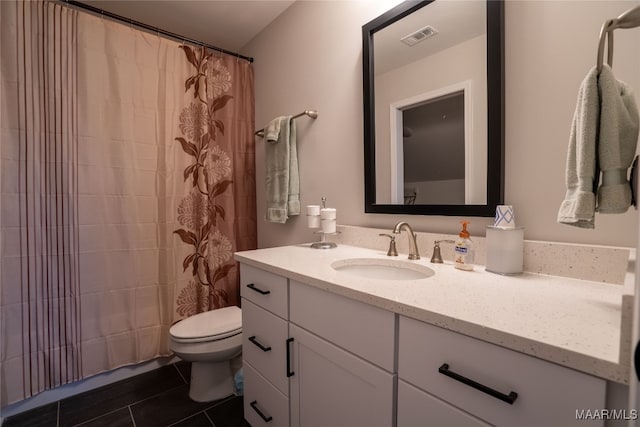 bathroom featuring tile patterned flooring, vanity, toilet, and a shower with curtain