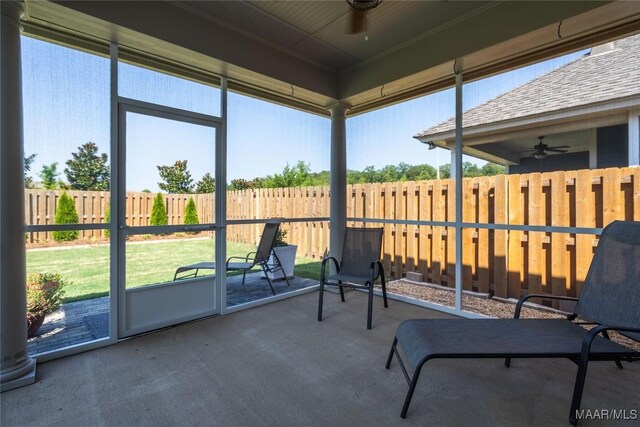 unfurnished sunroom with ceiling fan